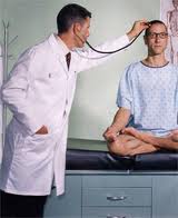 doctor puts a stethoscope to a man's head who is meditating