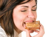 woman eating peanut butter on bread mindfully